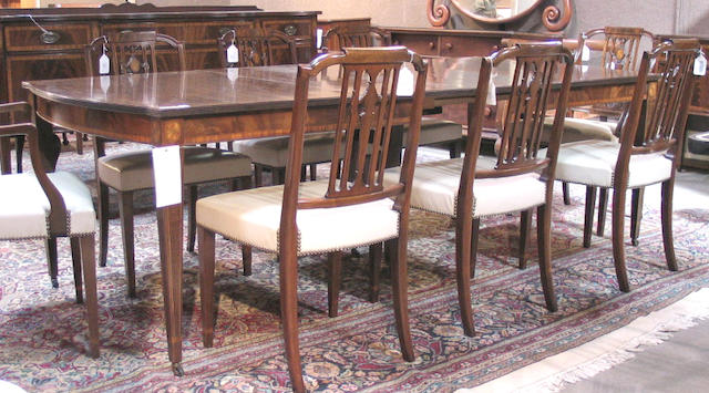 A Federal style inlaid mahogany dining suite comprising a table with four leaves, a sideboard, two armchairs and six side chairs
