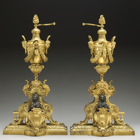 A pair of R&#233;gence style gilt and patinated bronze chenets