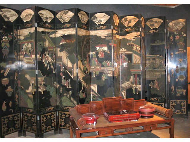A massive twelve panel black and polychrome lacquer coromandel screen
