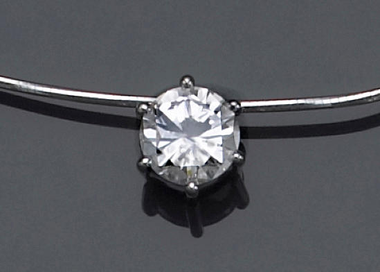 A diamond and fourteen karat white gold pendant-necklace