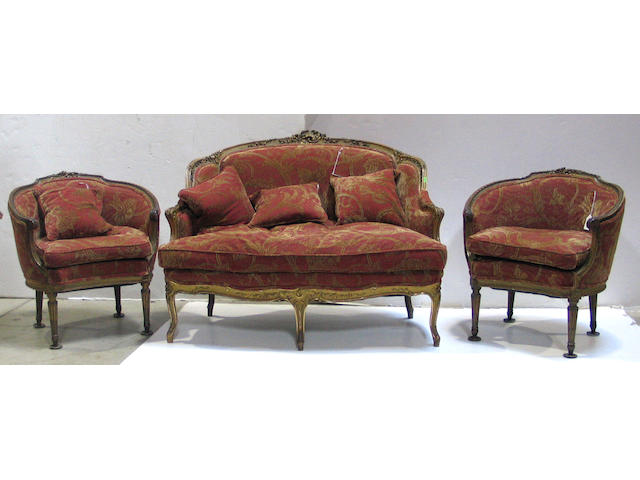 A Louis XV style parcel gilt assembled salon suite  comprising a settee and two bergeres