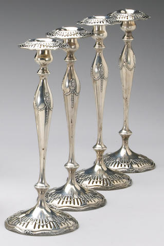 A set of four sterling candlesticks in the 'Marie Louise' pattern