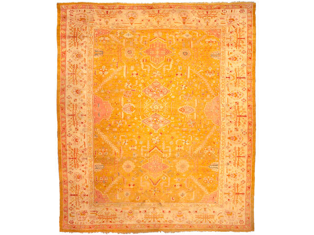 An Oushak carpet West Anatolia, Size approximately 14ft 6in x 12ft 7in