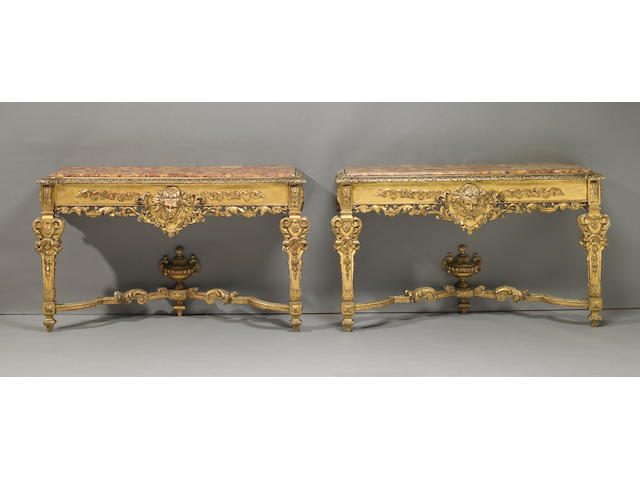 A pair of Italian Baroque style giltwood marble top console tables