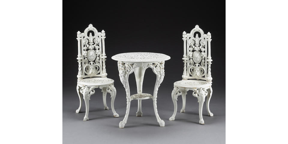 A Victorian cast iron garden table and pair of side chairs