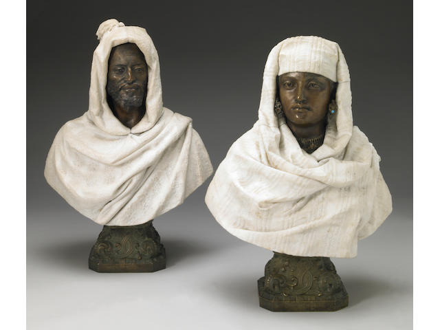 A pair of Italian patinated bronze and carved marble busts
