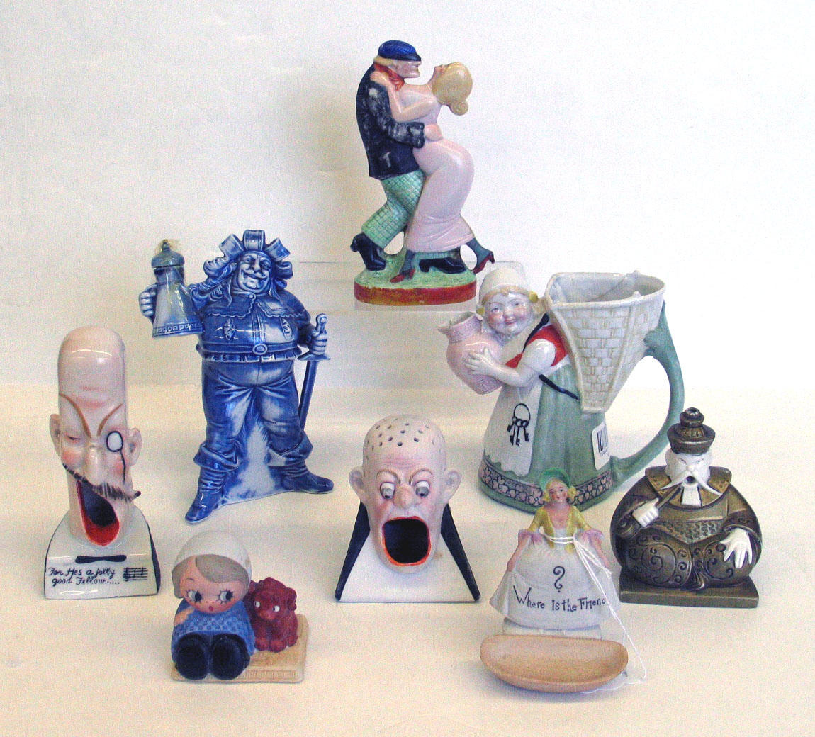 An assembled grouping of eight German porcelain figural ashtrays...