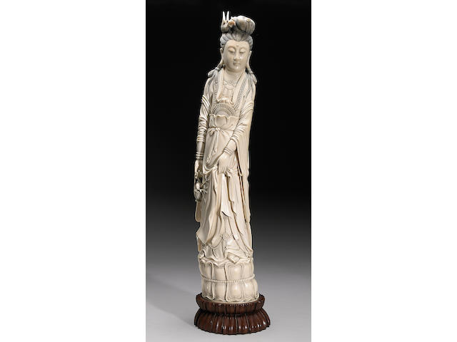 A large tinted ivory figure of Guanyin