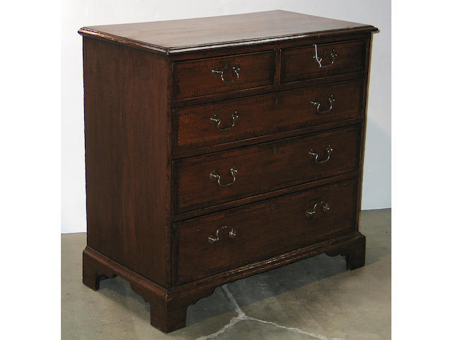 A George III crossbanded oak chest of drawers
