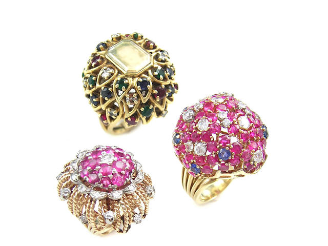 A collection of three ruby, diamond, and sapphire dome rings