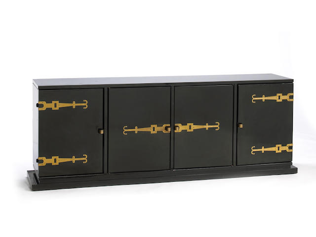 A Tommi Parzinger black lacquer and ebonized wood four door cabinet