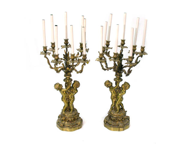 A pair of Louis XV style bronze figural eight light candelabra