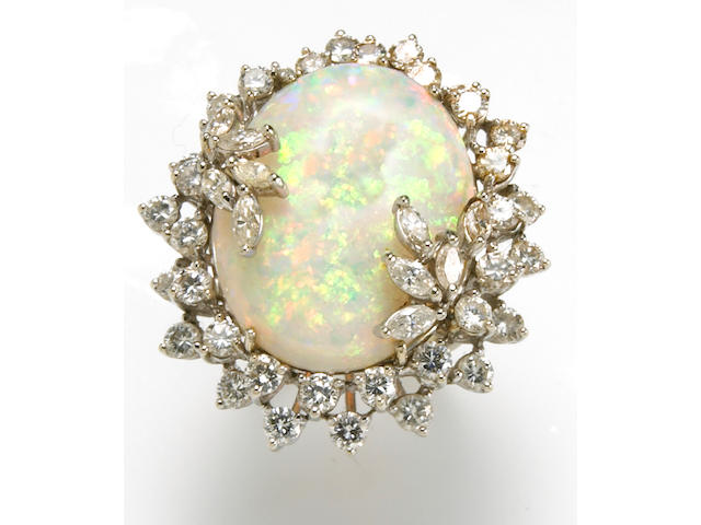 An opal, diamond and 14k white gold ring