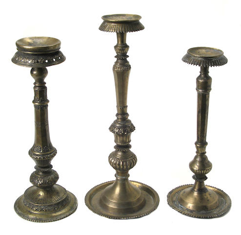 A group of three Tibetan bronze candlestands