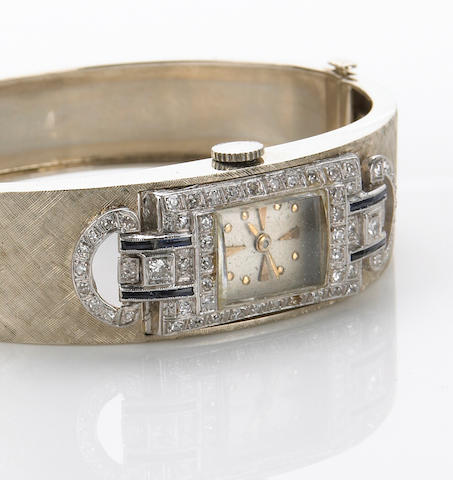 A lady's platinum, diamond and sapphire set watch within custom 14k gold bangle bracelet