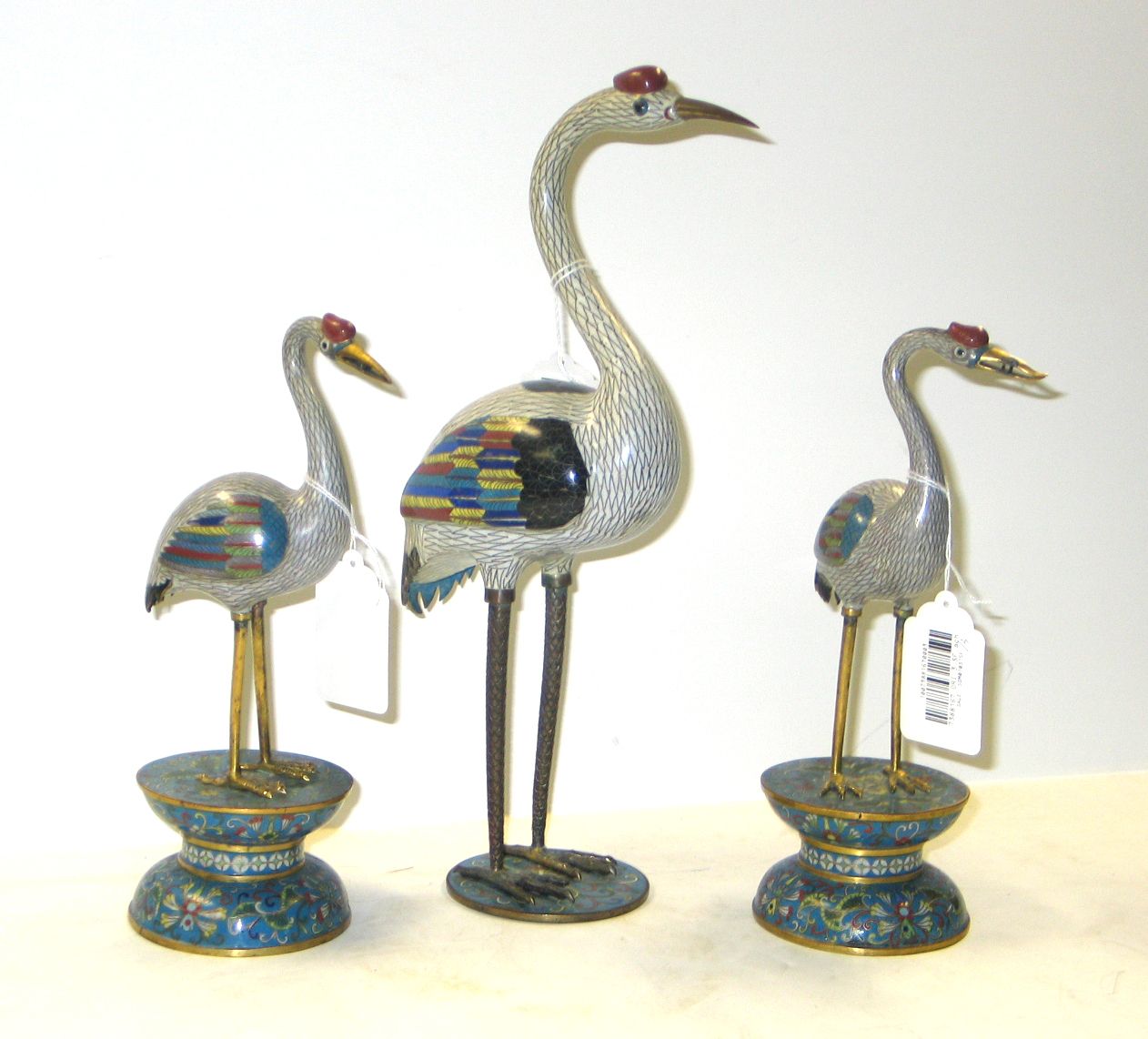 Three cloisonné cranes