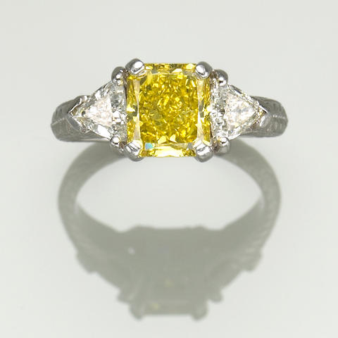 A treated yellow, white diamond and platinum ring
