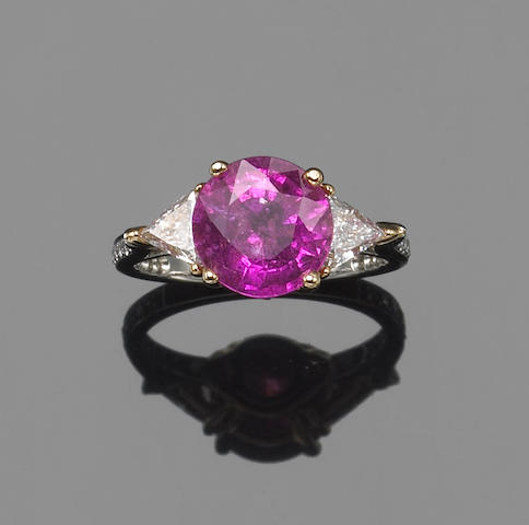 A pink sapphire, diamond, platinum and 18k white gold ring