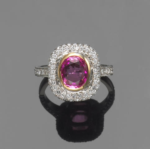 A pink sapphire, diamond, platinum and 18k gold ring