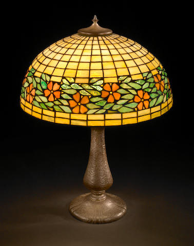 A Unique Art Glass & Metal Co. leaded glass and patinated-metal floral border lamp