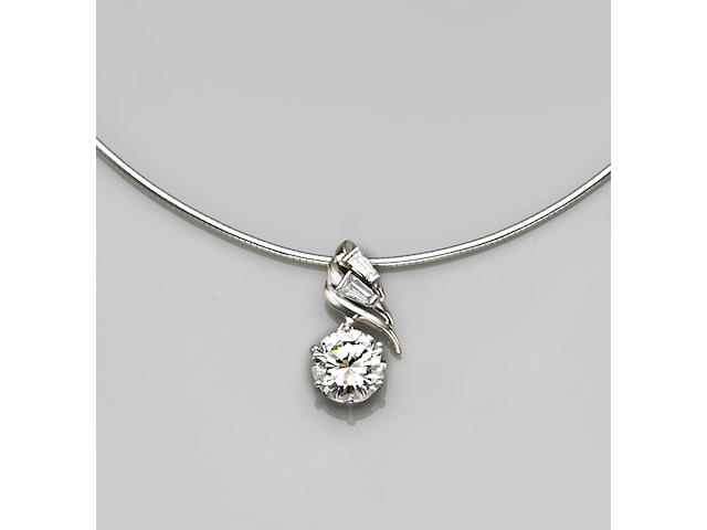 A diamond and fourteen karat white gold pendant and chain