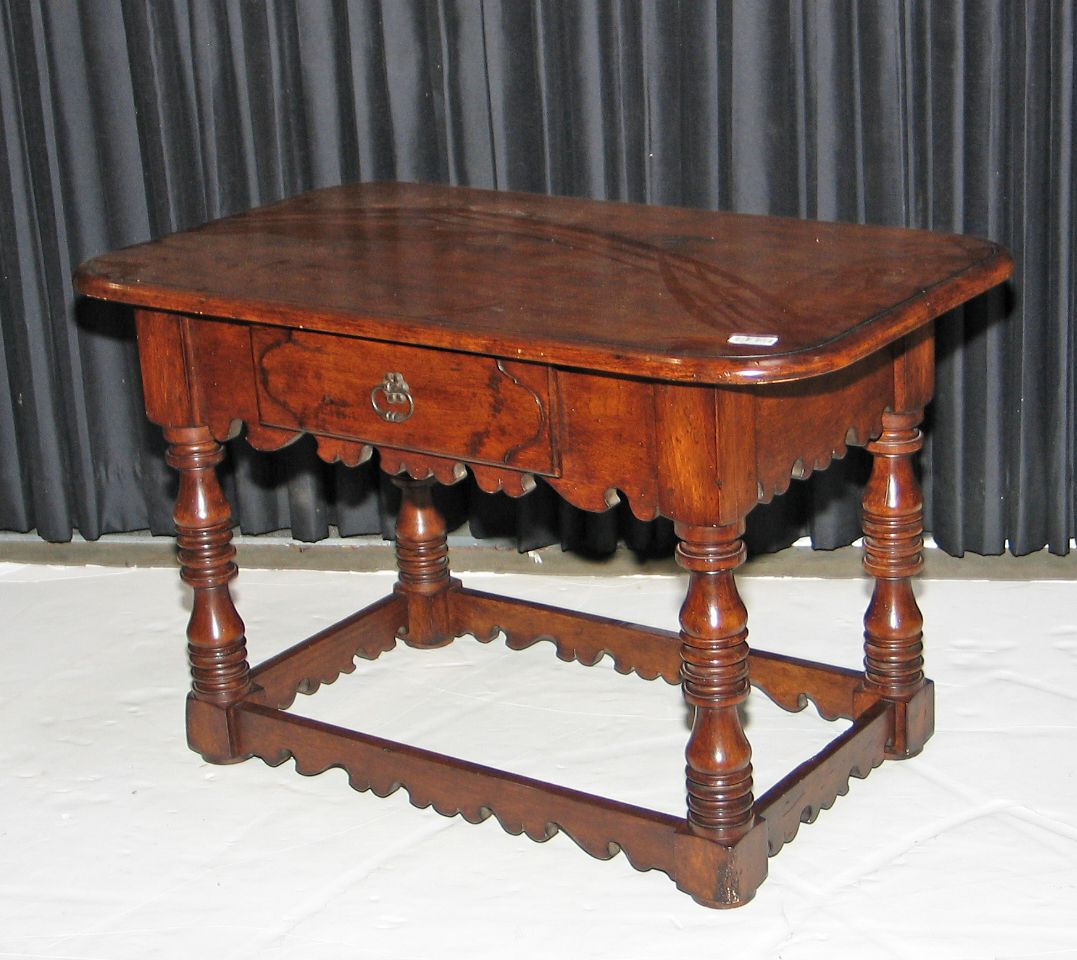 A Baroque style walnut table