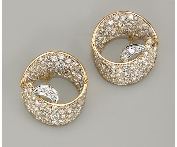 A pair of diamond, platinum and eighteen karat gold earrings