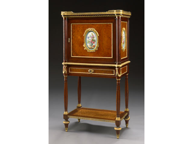 A Louis XVI style gilt bronze and porcelain mounted amboyna and mahogany cabinet
