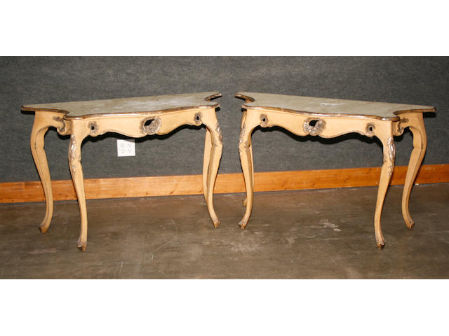 A pair of Italian Rococo style parcel gilt, faux marble  painted console tables