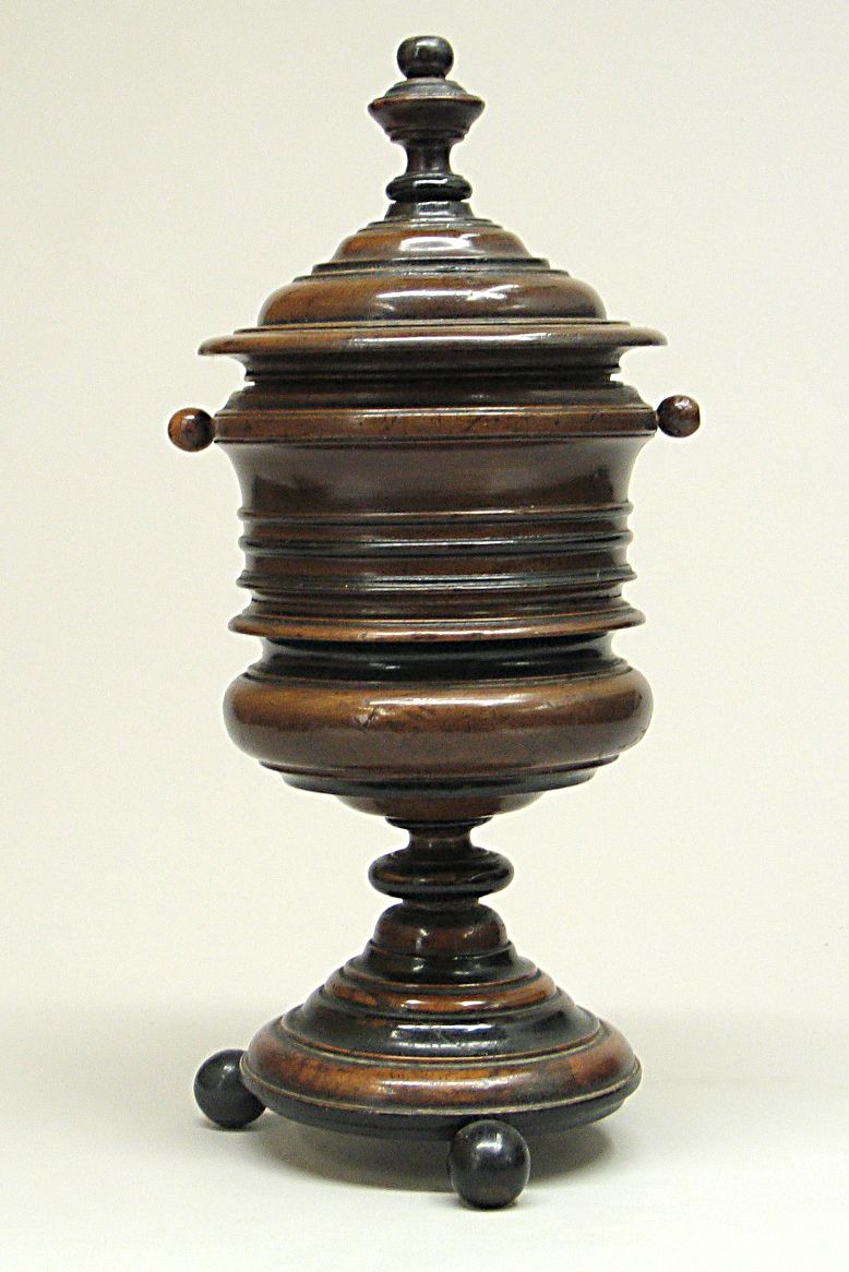 A partial ebonized covered treen cup
