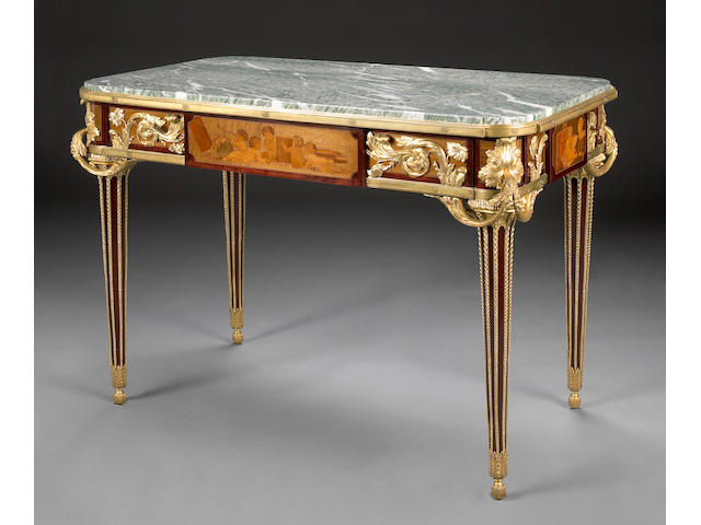 A Louis XVI style gilt bronze mounted marquetry center table