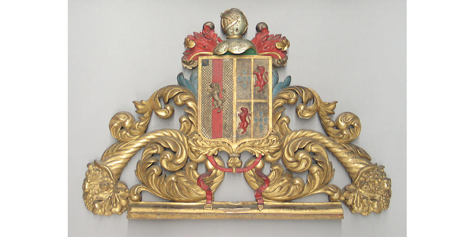 An Iberian Baroque style carved gilt and polychrome wood armorial pediment