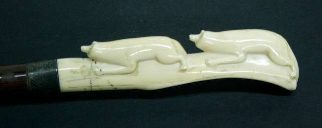 A walking stick with carved Eskimo ivory handle