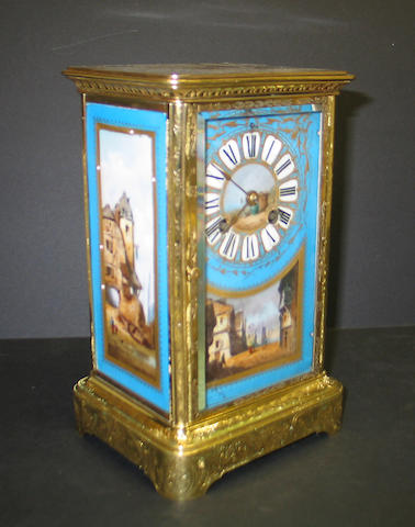 A French porcelain and engraved brass mantel clock