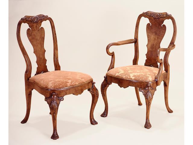 A set of twelve Queen Anne style carved walnut dining chairs