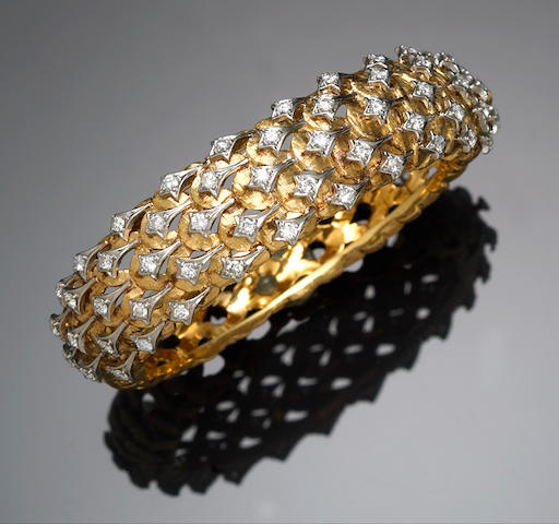 A diamond and fourteen karat gold bangle