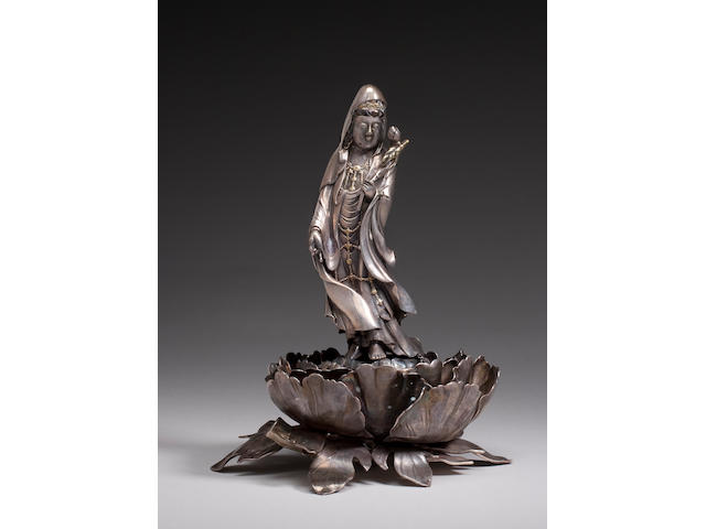 A silver figure of Kannon with gilt accents Meiji Period
