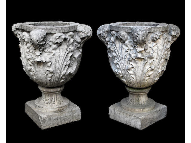 A fine pair of Italian Baroque Istrian marble urns on pedestals