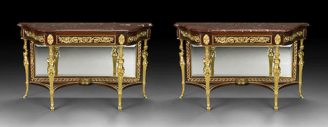 A pair of Louis XVI style gilt-bronze-mounted mahogany consoles
