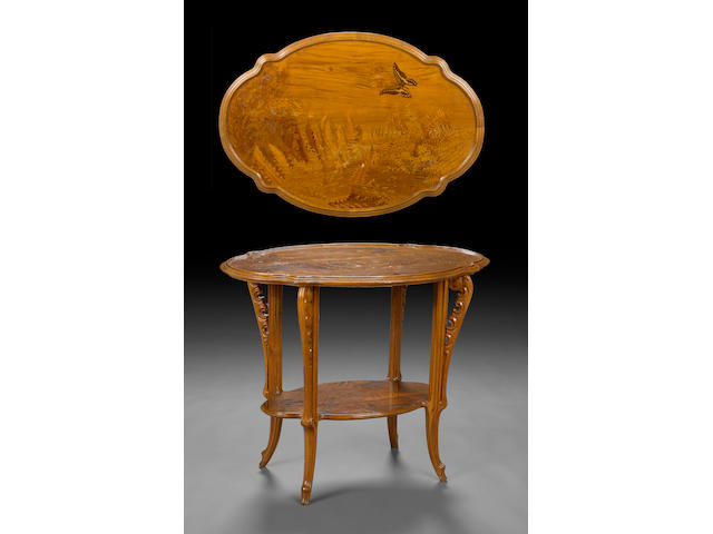 A Gall&#233;  marquetry inlaid walnut two tier table  circa 1900