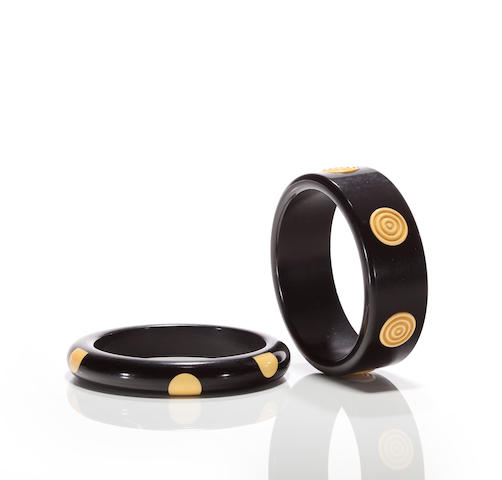 Two black and yellow Bakelite "dot" bangle bracelets