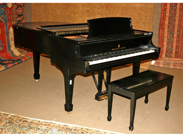 A Steinway ebonized grand piano together with bench