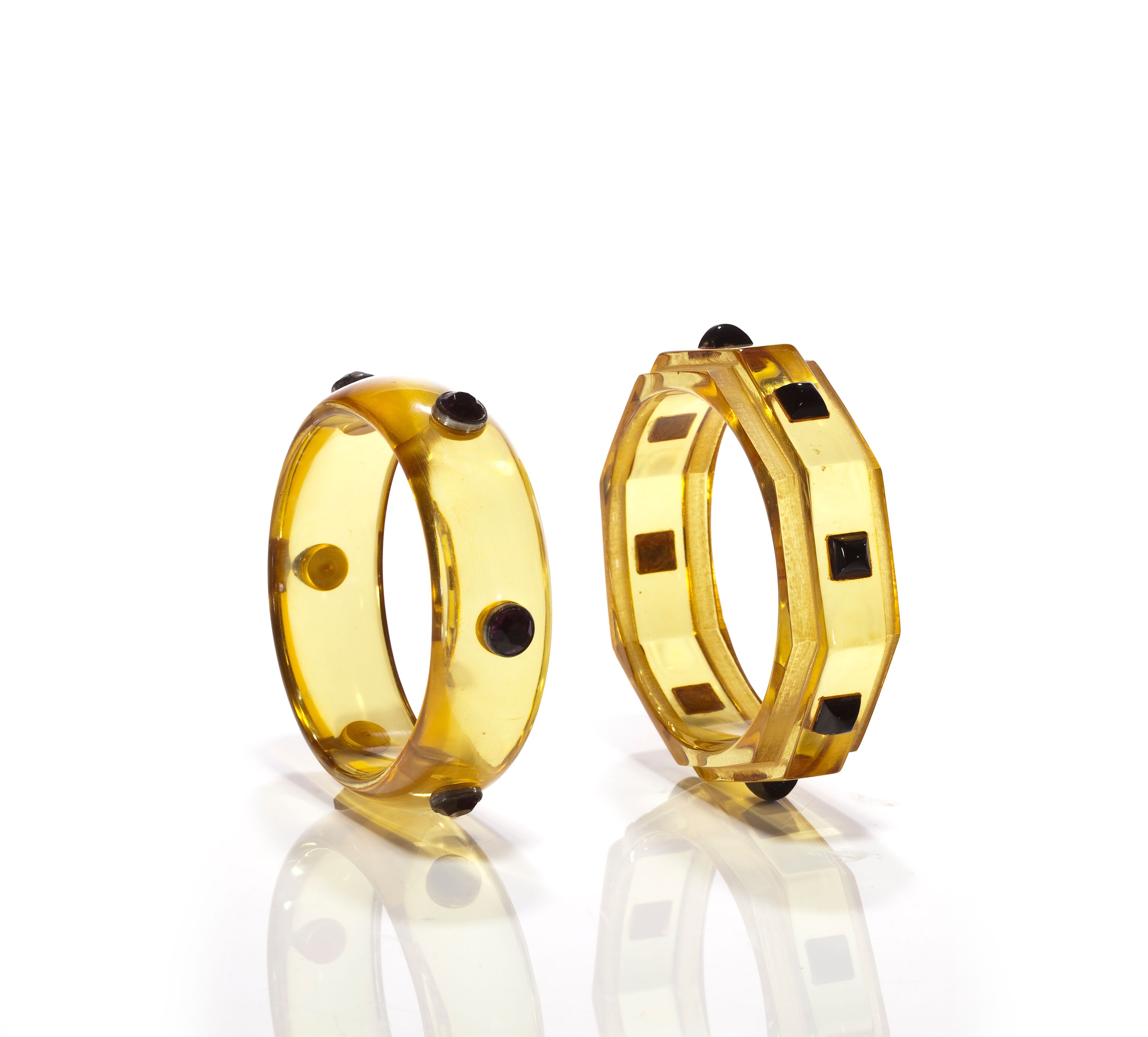 Two translucent yellow bangle bracelets