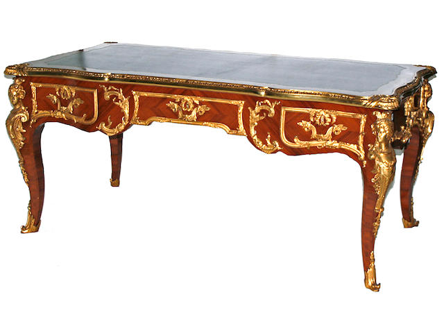 A Louis XV style gilt bronze mounted mahogany and kingwood bureau plat