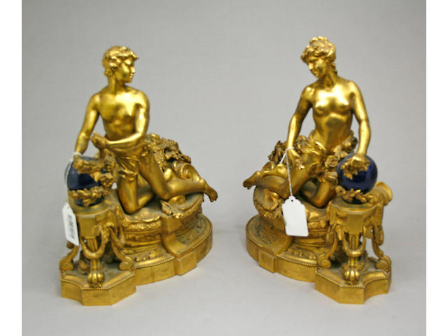A pair of Louis XVI style gilt bronze figural chenets