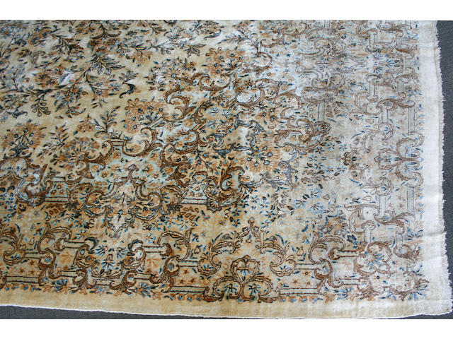A Kerman carpet size approximately 9ft. 11in. x 20ft.