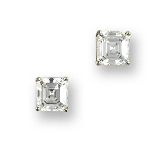 A pair of diamond solitaire earrings