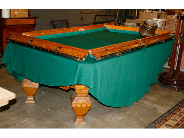 A Brunswick burled elm inlaid pool table together with a cue stand and a lamp shade