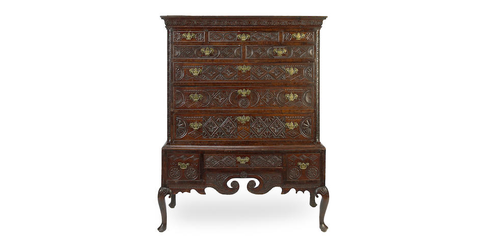 A George III oak and later carved chest on stand