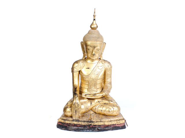 A monumental Southeast Asian gilt decorated carved wood seated Buddha